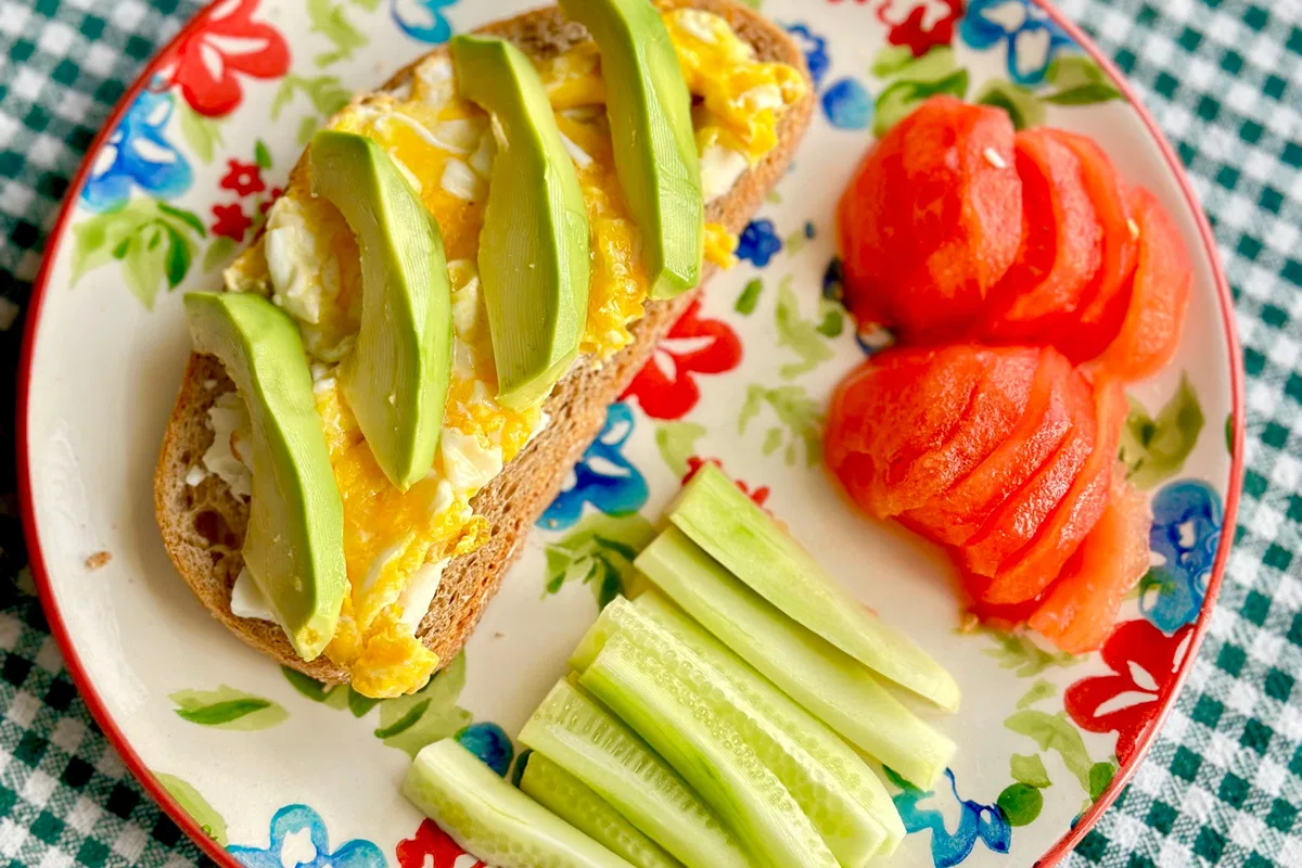 Avocado on wholegrain toast with tomatoes and vegetables.
