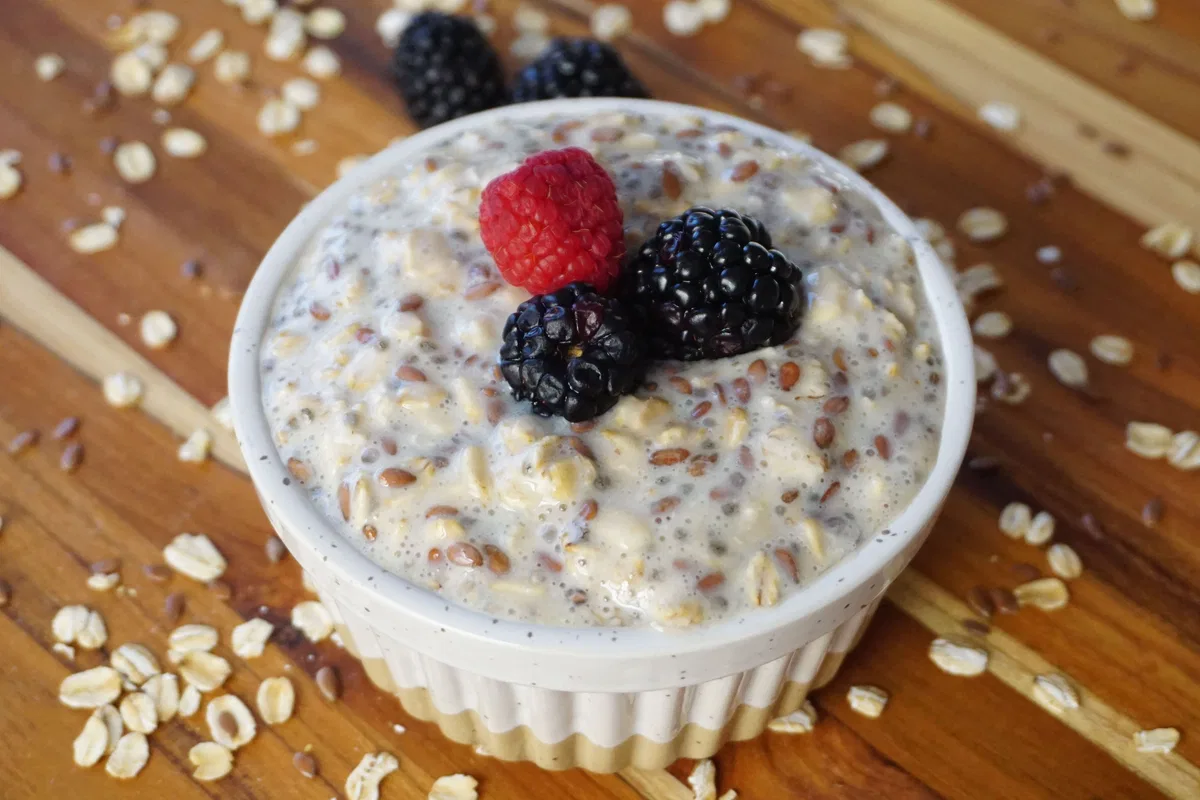 A bowl of porridge oats topped with mixed berries.
