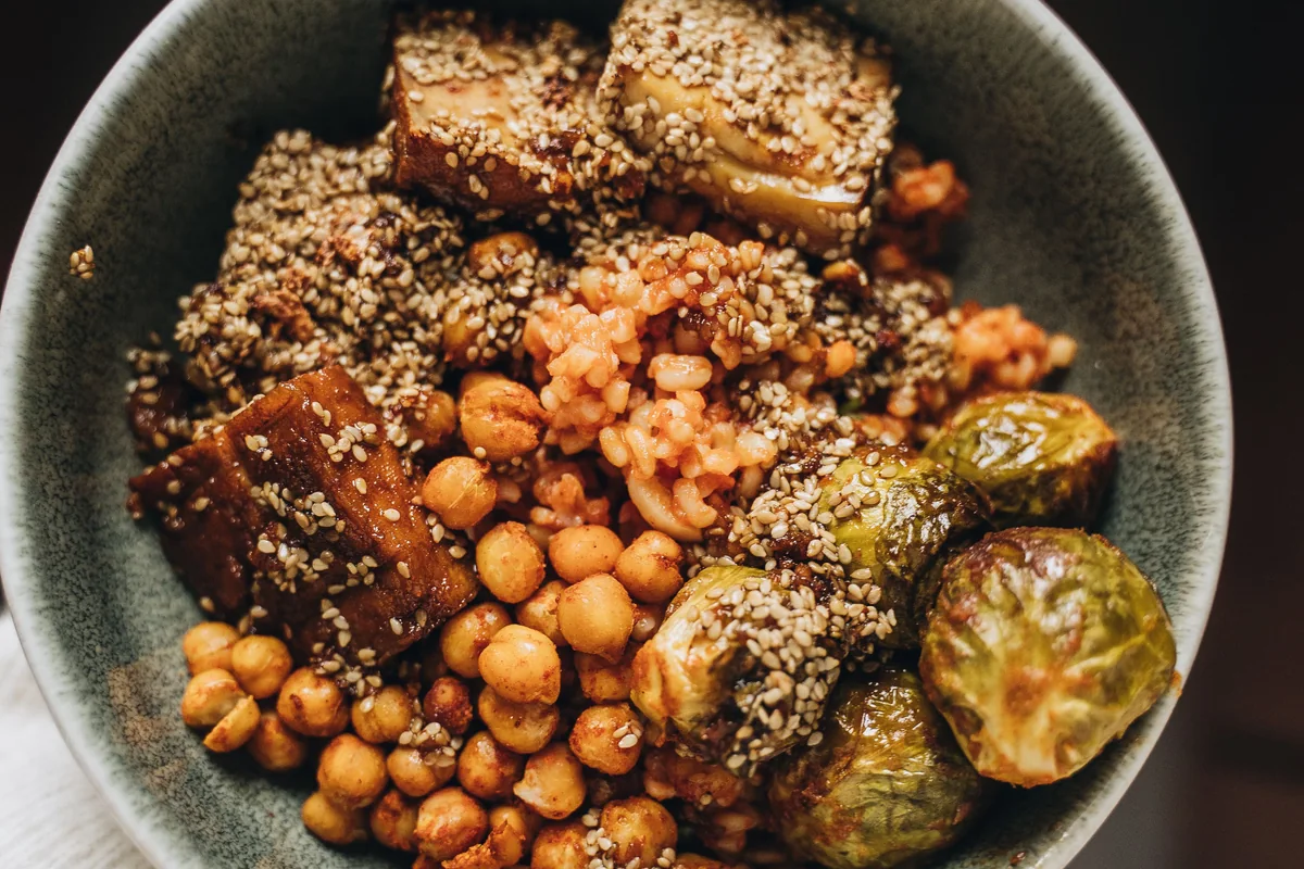 A vegetarian bowl with tofu, chickpeas and roasted vegetables.