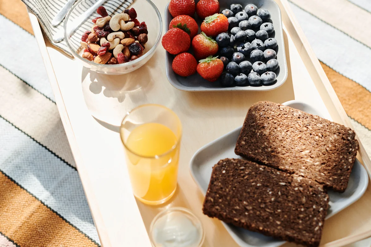 A breakfast table with wholegrain toast, berries and other everyday foods.