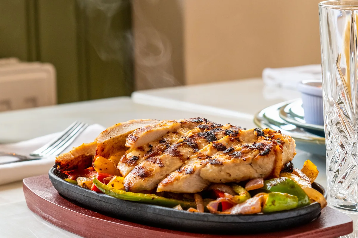 Grilled chicken served with mixed peppers, onions and courgette.