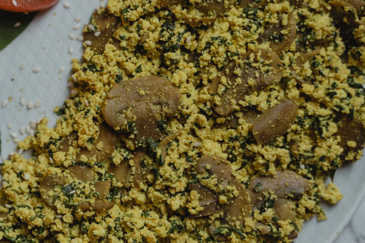 Golden tofu scramble with mushrooms and greens.